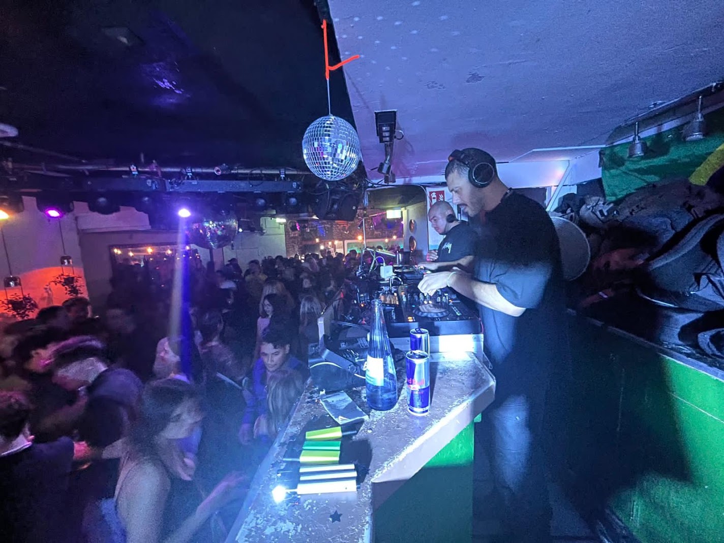 b.god in the DJ booth with crowd close by